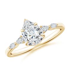 a yellow gold engagement ring with an oval cut diamond and pear shaped diamonds on the band