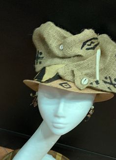 The art of the Zulu Hat. This hat is a cool classy look. It screams I'm Here. This is a wearable art hat. If you are looking for something Zulu, Kentucky Derby or just want to be different, this is the hat for you. This hat has 6 different looks. Every turn is a different look. Don't delay order yours today. Brown Brimmed Costume Hats For Beach, Brown Brimmed Costume Hats And Headpieces For Beach, Unique Festival Top Hat With Short Brim, Brown Bucket Hat For Festival, Vintage Beige Hat For Festival, Unique Short Brim Top Hat For Festivals, Vintage Beige Festival Hat, Artistic Adjustable Hat Bands For Fedora, Artistic Adjustable Fedora With Short Brim