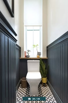 a white toilet sitting next to a window in a bathroom on top of a black and white checkered floor