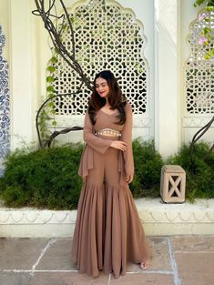 📌Hey! Please message us if you have any questions. We'll definitely assist you. This stunning ethnic combination consists of a lovely Faux Georgette Brown Sharara with an elaborate design and an Elegant Kodi Lace Top that oozes elegance and class. The Sharara is composed of high-quality Faux Georgette fabric that drapes nicely and is simple to care for. The Sharara's elaborate embroidered work is stunning, with delicate patterns and motifs that will make you stand out. The complementing Elegant Kodi Lace Top matches the Sharara well and boasts lovely lace trimming that adds a touch of glamour to the whole design. The costume is finished with a matching Shrug, which provides an added layer of flair and class. This Faux Georgette Brown Sharara with Elegant Kodi Lace Top Coord Set with Shrug Cheap Festive Women's Sharara, Indian Family Dress Set, Festive Sharara For Festivals, Cheap Sets With Pallu For Eid, Cheap Women's Sharara For Navratri, Brown Indian Long Dress, Luxury Eid Palazzo Set For Party, Luxury Semi-stitched Georgette Sharara, Traditional Cheap Sharara For Festive Season