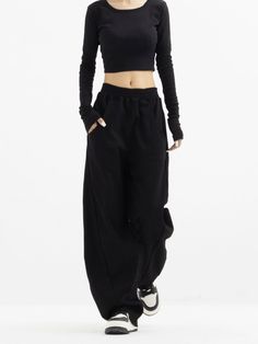 Embrace a touch of sophistication with our High-Waisted Wide-Leg Paneled Joggers, blending casual comfort with a polished finish.
  Crafted from 100% modified polypropylene fiber, these joggers offer a soft knit texture and a structured wide-leg silhouette. The high waist design is both flattering and practical, lending itself to a variety of versatile styling options.
  Perfect for an understated office look or a relaxed weekend outfit, pair these joggers with a fitted turtleneck and ankle boot Modern High Waist Stretch Bottoms, Modern Stretch High Waist Bottoms, Modern High-waist Stretch Bottoms, Fitted Full Length Bottoms With Elastic Side Panels, Modern Fitted Solid Bottoms, High Waist Solid Joggers For Streetwear, Trendy Black Bottoms With Ribbed Waistband, Straight Leg Bottoms With Elastic Side Panels, Black Stretch Bottoms With Elastic Side Panels