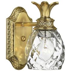 a glass and brass wall light with a pineapple design