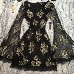 Lulus Black And Gold Lace Flounce Sleeve Dress. Sheer Long Sleeves. Lined. New With Tags Size Small Black And Gold Dress Short, Black And Gold Ball Gown, Black Bohemian Dress, Black And Gold Outfit, Gold Dress Short, Flounce Sleeve Dress, Gold Lace Dresses, Dresses Lulus, Gold Prom Dresses