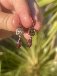 Cute vintage pair of earrings, these are made with sterling silver and Garnet gemstones. Please see photos for approximate measurements. The back of these are marked FF for the maker of the earrings. Garnet Earrings, The Maker, Sunset Beach, Garnet Gemstone, Vintage Earrings, Vintage Sterling Silver, Favorite Jewelry, Garnet, Jewelry Earrings Dangle