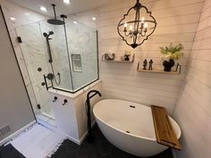 a bath tub sitting next to a walk in shower