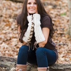 a woman sitting on a log in the woods