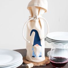 a wine bag sitting on top of a table next to a glass of red wine