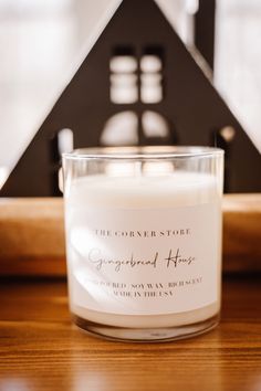 a white candle sitting on top of a wooden table