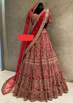 a red and gold bridal gown on display