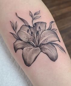 a black and white flower tattoo on the arm