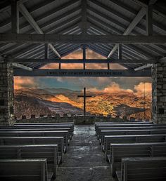 an empty church with mountains in the background