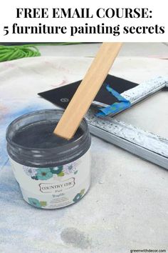 a jar of paint next to a brush on a table with the words, free email course 5 furniture painting secrets