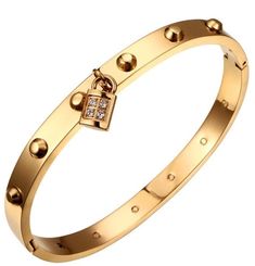 Very trendy Gold over Stainless steel bracelet with cubic a lock.  6 cm diameter. Oval shaped. Hinged jewelry. No return policy, but please feel free to reach out with any questions or concerns before you purchase teh item. Thank you for visiting my store. Item care: Since this item is not solid gold , we recommend to avoid liquids, perfumes and lotions being applied directly on the product. Please keep your jewelry dry at all time, and allow a few minutes after application of lotion or perfume, before wearing your beautiful pieces. To prevent your jewelry from becoming temporarily darkened due to buildup, clean often, using a soft cloth or microfiber towel to wipe away dirt and/oil build up after use. Rings Dainty, Cz Bracelet, Bangle Jewelry, Earrings Rings, Crystal Drop Earrings, Cartier Love Bracelet, Stunning Jewellery, Crystal Bracelet, Jewelry Gold