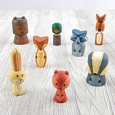 small ceramic animal figurines sitting on top of a wooden table