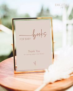 a sign that says for baby books on it sitting on top of a wooden table