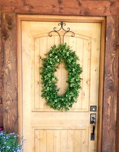 a wooden door with a wreath on it