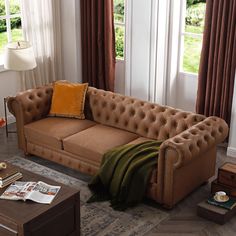 a living room with a couch, coffee table and two lamps on the side tables