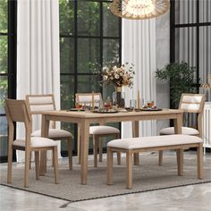 a dining room table with four chairs and a bench