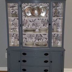 a china cabinet with plates and bowls on it