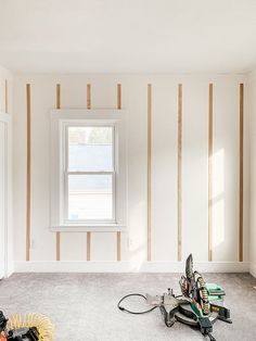 an empty room with some tools on the floor in front of a window that has been stripped off