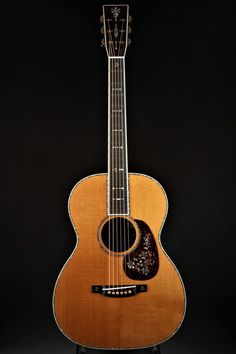 an acoustic guitar is shown against a black background with the strings still attached to it