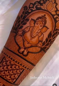 an intricately decorated arm with the image of ganesh on it