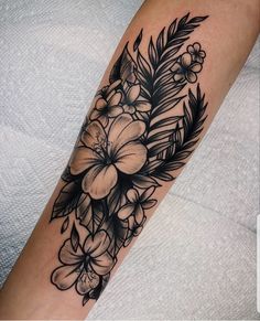 a black and white flower tattoo on the arm