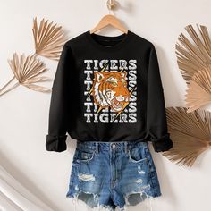 This makes the perfect vintage school spirit Tigers sweatshirt! This tigers sweatshirt is great for showing your school spirit! This distressed vintage tiger design is perfect on the popular Gildan brand sweatshirt. This vintage style sweatshirt will keep you warm throughout the school season!  A pre-shrunk, classic fit sweater that's made with air-jet spun yarn for a soft feel and reduced pilling. ** P R O D U C T **  - 50% cotton, 50% polyester  - Pre-shrunk  - Classic fit  - Direct to Garment print (no stencils or vinyl which means it will last a lot longer)   - Printed and Shipped in the USA  - Due to different monitor screens colors may vary ** S I Z I N G **  - Consult size chart in listings for measurements  - Sizing is Unisex for all tees, runs true to size  - For an oversized fit, School Varsity Sweatshirt, Collegiate Sweatshirt With Letter Print For School, Collegiate Style Sweatshirt With Letter Print For School, School Spirit Tops With Letter Print For Campus, School Spirit Letter Print Tops For Campus, Campus Letter Print Tops For School Spirit, School Team Spirit Sweatshirt With Letter Print, Collegiate Letter Print Sweatshirt For School, School Spirit Graphic Print Tops For Campus