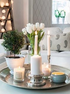 a tray with candles and flowers on it