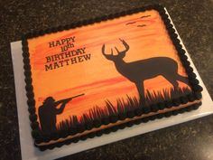 a birthday cake decorated with an image of a deer and hunter