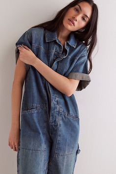 Effortlessly cool and done-in-one, this jumpsuit from our We The Free collection features a classic denim fabrication and button closures with drop-shoulder sleeves. **Fit:** Shapeless, relaxed fit **Features:** Cotton denim fabrication, collared neckline, drop-shoulder short-sleeves, button-front closures, contrast seams, 4-pocket styling, utility-inspired details **Why We ❤ It:** This versatile one-piece pairs perfectly with everything from femme flats to cool sneakers and bold boots. | We The