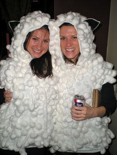 two women dressed in sheep costumes holding cans