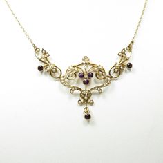 "Victorian/1800s 14k yellow gold natural amethysts and seed pearls 18.5\" long condition: excellent Stunning Victorian necklace, crafted of 14 karat yellow gold and set with natural amethysts and seed pearls.  The necklace is 18.5\" long, and features an openwork center motif set with six 3mm round bezel-set natural amethysts, surrounded by dainty seed pearls in a floral setting.  This necklace is so lovely! The necklace is in excellent condition, with no damage to the gemstones or setting.  It Antique Jewelry Victorian Vintage Jewellery Pendant Necklace, Gold Art Nouveau Necklace With Gemstone, Art Nouveau Gold Necklace With Gemstone, Antique Yellow Gold Pearl Necklace For Wedding, Art Nouveau Yellow Gold Gemstone Necklaces, Victorian Purple Necklace For Anniversary, Antique Gemstone Necklace For Wedding, Ornate 14k Gold Wedding Necklace, Ornate 14k Gold Necklace For Wedding