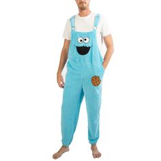 If you love cookies just as much as Sesame Street's Cookie Monster, we know you'll also love these blue Cookie Monster character unisex sleep wear Jammerall Sleepwear! The Sesame Street Cookie Monster character unisex fan merchandise is a pair of blue sleep wear overalls made of 100% polyester coral fleece material and is designed with a big face of the Cookie Monster on the front of the overalls. The Cookie Monster blue overalls sleep apparel is available in unisex sizes ranging from S - XXL an Cookie Costume, Sesame Street Cookies, Classic Halloween Costumes, Sesame Street Cookie Monster, Blue Cookies, Blue Overalls, One Piece Clothing, Mens Sleepwear, One Piece Pajamas