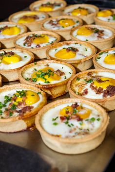 many small pies with eggs in them on a table