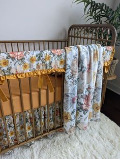 a baby crib with a blanket on top of it