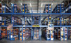 the inside of a warehouse filled with lots of shelves