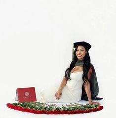 a woman sitting on the floor with roses around her