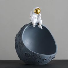 an astronaut is sitting on top of the moon