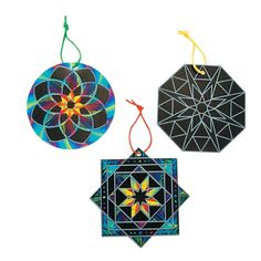 three ornaments are hanging from strings on a white background and one has an ornament in the shape of a flower