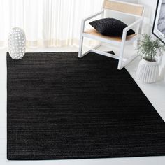 a black area rug in a white room