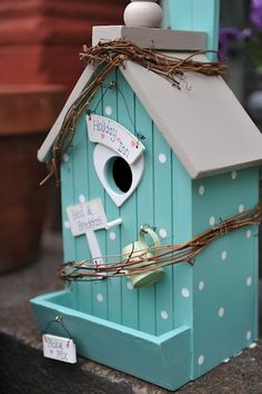 a blue birdhouse with white polka dots on it