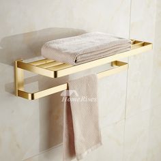 a towel is hanging on a gold shelf