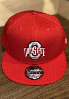 a red snapback hat with the word ohio state on it