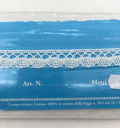 a white lace is on top of a blue package with the words art n, metro