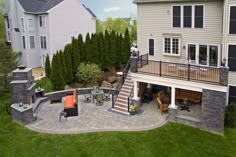 an aerial view of a patio with seating and fire pit in the middle of it