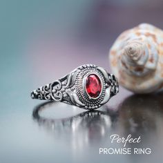 a close up of a ring on a table with a shell in the foreground