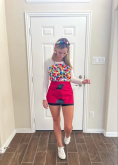 a woman in red shorts and a colorful shirt