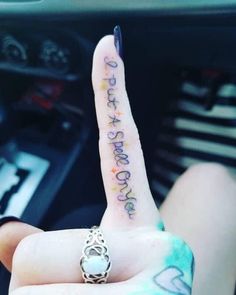 a person is holding up their finger with the word love written on it