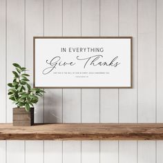 a sign that says in everything give thanks above a potted plant on a shelf